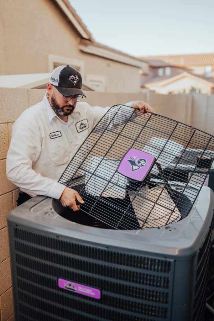 Penguin Air associate checking an AC unit