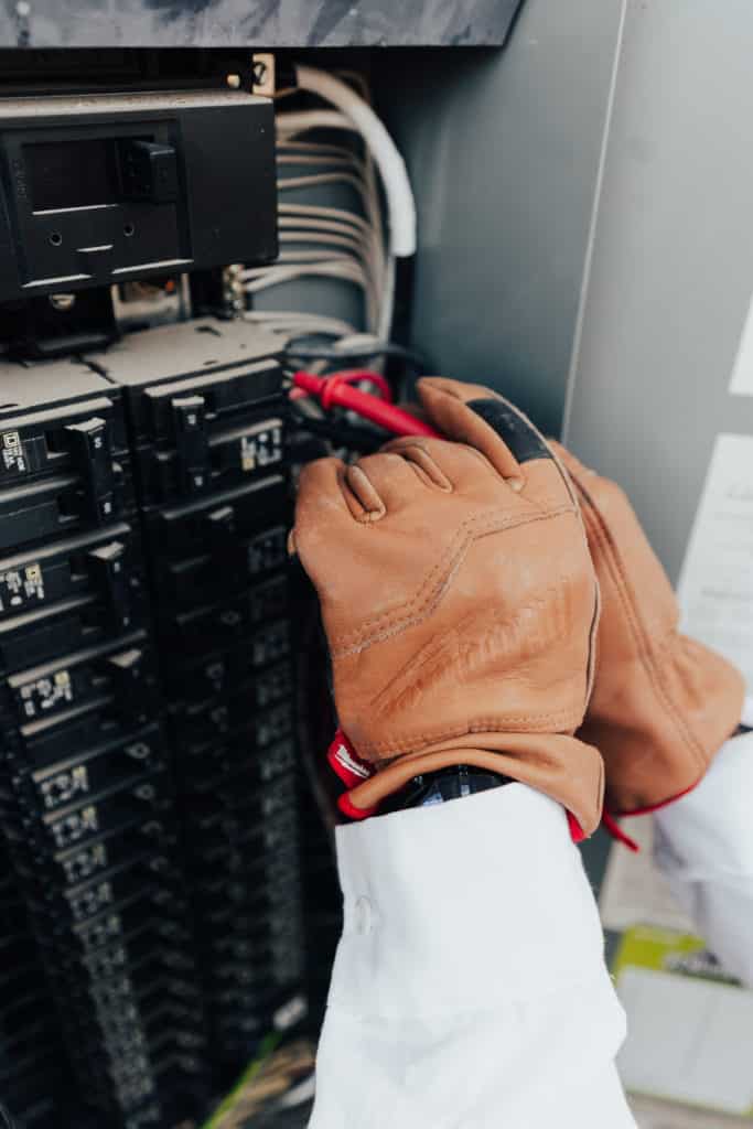 Penguin Air associate wokring on an electrical power panelboard