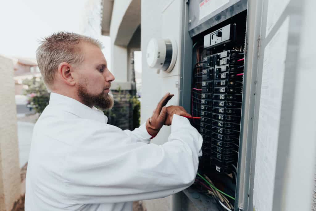 technician servicing home's electrical panel