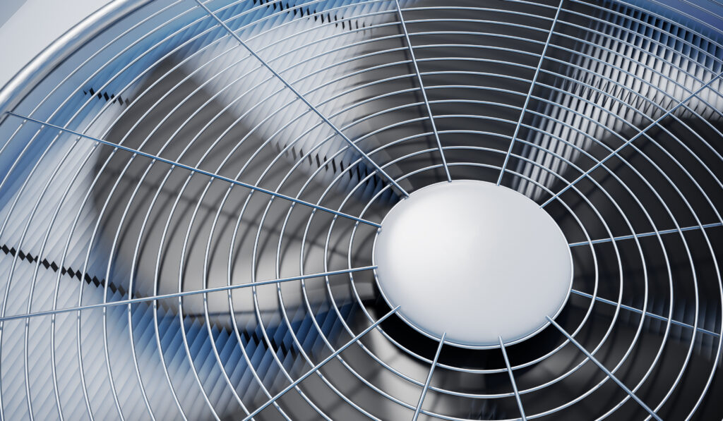 Close-up view of a spinning fan on an HVAC unit.
