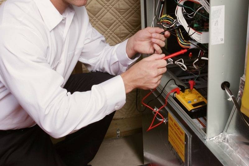 HVAC technician working on a furnace.